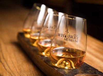 Four whiskey glasses with whiskey at irish whiskey museum